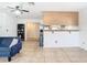 Inviting living room showcases tile floors, a modern ceiling fan, and seamless access to the kitchen at 23 Judith Ln, Orlando, FL 32811