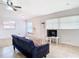 Well-lit living room with tile flooring, a ceiling fan, and an open layout at 23 Judith Ln, Orlando, FL 32811