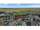 A serene aerial view of homes in a residential area near a golf course and green space at 2383 Victoria Dr, Davenport, FL 33837