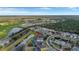 An aerial view of a residential area showcasing homes, a golf course, and the surrounding landscape at 2383 Victoria Dr, Davenport, FL 33837