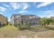 View of the backyard featuring a screened pool and ample lawn space perfect for relaxing and entertaining at 2383 Victoria Dr, Davenport, FL 33837