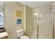 Well-lit bathroom with a glass door shower and light colored tile surround at 2383 Victoria Dr, Davenport, FL 33837