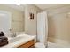 Bright bathroom with a shower and tub combination and a white shower curtain at 2383 Victoria Dr, Davenport, FL 33837