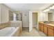 Bright bathroom features a soaking tub, glass shower and double sink vanity at 2383 Victoria Dr, Davenport, FL 33837