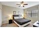 Comfortable bedroom with neutral colored walls and carpet, a ceiling fan, and a king-size bed at 2383 Victoria Dr, Davenport, FL 33837