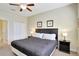 Inviting bedroom features neutral walls and carpet, complete with a king-size bed and ceiling fan at 2383 Victoria Dr, Davenport, FL 33837