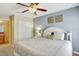 Bedroom featuring a queen bed, ceiling fan, and access to an attached bathroom at 2383 Victoria Dr, Davenport, FL 33837