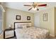 Cozy bedroom with neutral walls, ceiling fan, and comfortable bed with floral pattern bedding at 2383 Victoria Dr, Davenport, FL 33837