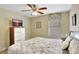 Serene bedroom with a floral bedding, a ceiling fan and a mounted TV for ultimate relaxation at 2383 Victoria Dr, Davenport, FL 33837