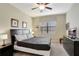 Cozy bedroom featuring neutral walls and carpet, complete with a dresser and mounted TV at 2383 Victoria Dr, Davenport, FL 33837