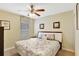 Bright bedroom with floral bedding, ceiling fan, and natural light from window at 2383 Victoria Dr, Davenport, FL 33837