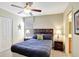 Bedroom features a ceiling fan, closet and two side tables with lamps at 2383 Victoria Dr, Davenport, FL 33837