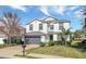 Charming two-story home featuring a gray roof, two-car garage, and manicured front lawn at 2383 Victoria Dr, Davenport, FL 33837