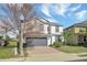 Charming two-story home with a gray roof, a two-car garage, and a well-maintained lawn at 2383 Victoria Dr, Davenport, FL 33837