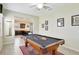 Game room with pool table, adjacent to the kitchen, provides a great entertaining space at 2383 Victoria Dr, Davenport, FL 33837