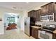 Open kitchen adjacent to a game room featuring stainless steel appliances and granite countertops at 2383 Victoria Dr, Davenport, FL 33837