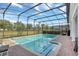 Inviting screened pool featuring a brick deck and a scenic view of the lush green landscape at 2383 Victoria Dr, Davenport, FL 33837