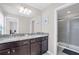 Elegant bathroom with granite countertops, dual sinks, and a glass-enclosed shower at 2483 Dubai St, Kissimmee, FL 34747