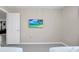 Bright bedroom with tile flooring and beach scene displayed on TV mounted on the wall at 2483 Dubai St, Kissimmee, FL 34747