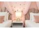 Charming ' bedroom features two beds with pink princess canopy decor and rainbow bedside lamp at 2483 Dubai St, Kissimmee, FL 34747