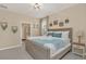 Comfortable bedroom with a wooden frame bed, decorated with plants and blue accents at 2483 Dubai St, Kissimmee, FL 34747