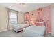 Charming ' bedroom features two beds with pink princess canopy decor and crown accents on wall at 2483 Dubai St, Kissimmee, FL 34747