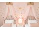 Charming ' bedroom features two beds with pink princess canopy decor and crown accents on wall at 2483 Dubai St, Kissimmee, FL 34747