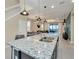 Modern kitchen island featuring granite countertops, stainless steel sink and stylish pendant lighting fixtures at 2483 Dubai St, Kissimmee, FL 34747