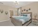 Main bedroom with a wooden bed, blue accents, decorative wall hangings, and an en-suite bathroom at 2483 Dubai St, Kissimmee, FL 34747