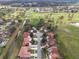 An aerial view of a community with lush landscaping and tile roofs adjacent to a golf course at 2625 Albion Ave, Orlando, FL 32833