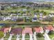 An aerial view displays a golf course behind homes, complemented by a tranquil water feature at 2625 Albion Ave, Orlando, FL 32833