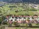 Aerial view of a residential community adjacent to a lush golf course with ponds and mature trees at 2625 Albion Ave, Orlando, FL 32833