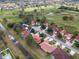 Overhead view featuring a neighborhood of single-Gathering homes with terracotta roofs, set against a backdrop of golf course greenery at 2625 Albion Ave, Orlando, FL 32833