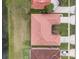 An aerial view of the house showing the tile roof, landscaping, and nearby water feature at 2625 Albion Ave, Orlando, FL 32833