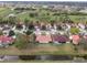 An aerial view of a neighborhood with lush landscaping, tile roofs, and water features at 2625 Albion Ave, Orlando, FL 32833