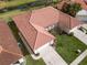 An aerial view of the house showing the tile roof, landscaping, and driveway at 2625 Albion Ave, Orlando, FL 32833