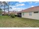 The backyard has a tile roof, lawn space, and a view to neighboring houses at 2625 Albion Ave, Orlando, FL 32833