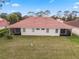 An aerial view of the home's backyard featuring lush green grass and a screened in lanai at 2625 Albion Ave, Orlando, FL 32833