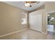 Well-lit bedroom with ceiling fan, window, tile flooring, and a closet with standard double doors at 2625 Albion Ave, Orlando, FL 32833