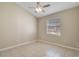 Neutral bedroom with tiled floors, a ceiling fan, and a window with blinds for natural light at 2625 Albion Ave, Orlando, FL 32833