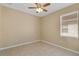 Standard sized bedroom with neutral walls, tile floor, ceiling fan and a window providing natural light at 2625 Albion Ave, Orlando, FL 32833