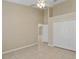 Spacious bedroom featuring high ceilings, tile floors, ceiling fan, and a double door closet at 2625 Albion Ave, Orlando, FL 32833