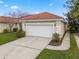 Lovely home featuring an attached garage, well-kept lawn, and a red tile roof at 2625 Albion Ave, Orlando, FL 32833