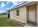 Side exterior view shows well-kept lawn and access to screened patio, with front door visible at 2625 Albion Ave, Orlando, FL 32833