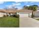 Well-maintained home showcasing a red-tiled roof, green lawn, and two-car garage at 2625 Albion Ave, Orlando, FL 32833