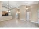 Open-concept living room with neutral tones, tile flooring, and a view of the breakfast bar at 2625 Albion Ave, Orlando, FL 32833