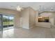 Bright, open-concept living room flows into the kitchen and outdoor screened patio at 2625 Albion Ave, Orlando, FL 32833