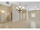 Open-concept living room with high ceilings, neutral walls and floors, and a decorative chandelier at 2625 Albion Ave, Orlando, FL 32833