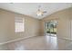 Spacious living room with neutral tile flooring, ceiling fan, and sliding glass doors at 2625 Albion Ave, Orlando, FL 32833