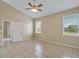 Spacious bedroom with tile floors, a ceiling fan, and large windows at 2625 Albion Ave, Orlando, FL 32833